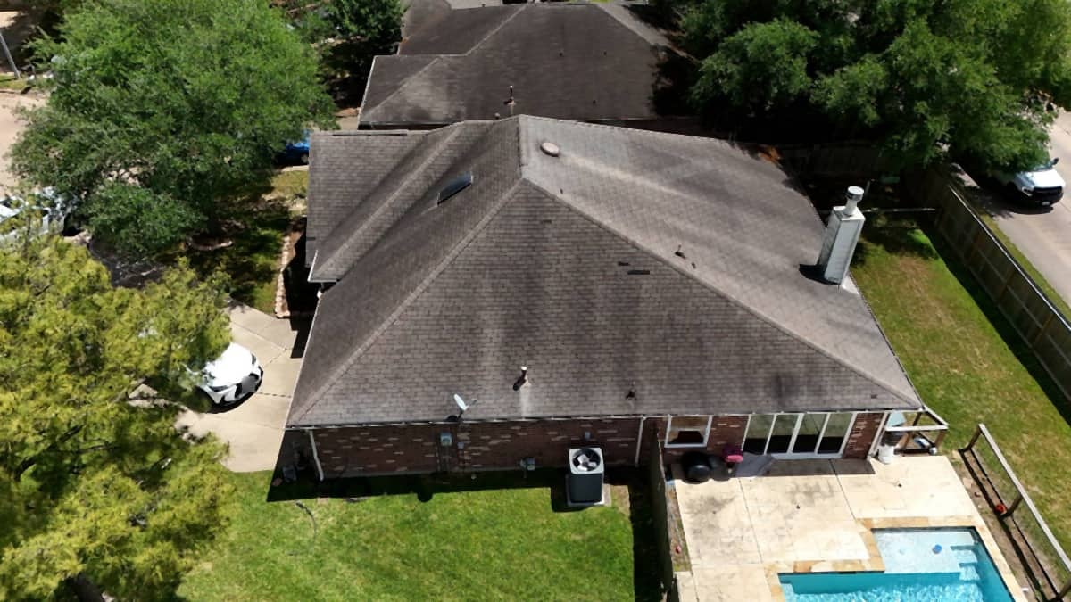 Before: hail-bruised builder-grade shingle roof on a Round Rock home
