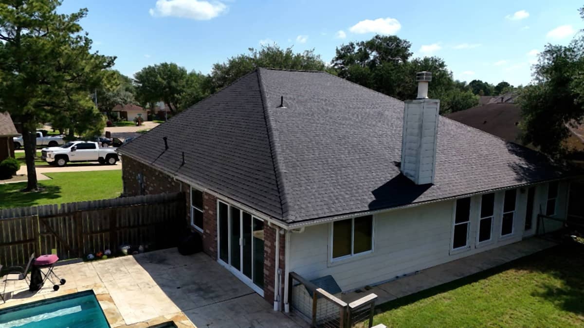 After: repaired and matched shingle section on a Pflugerville roof