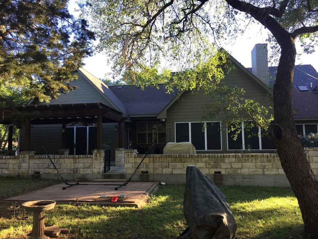 Before: failed underlayment visible beneath lifted clay tiles on a West Austin roof