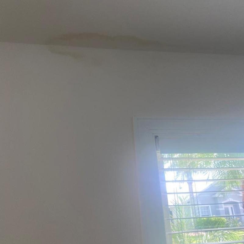 Ceiling water stain in an Austin home living room below a roof leak