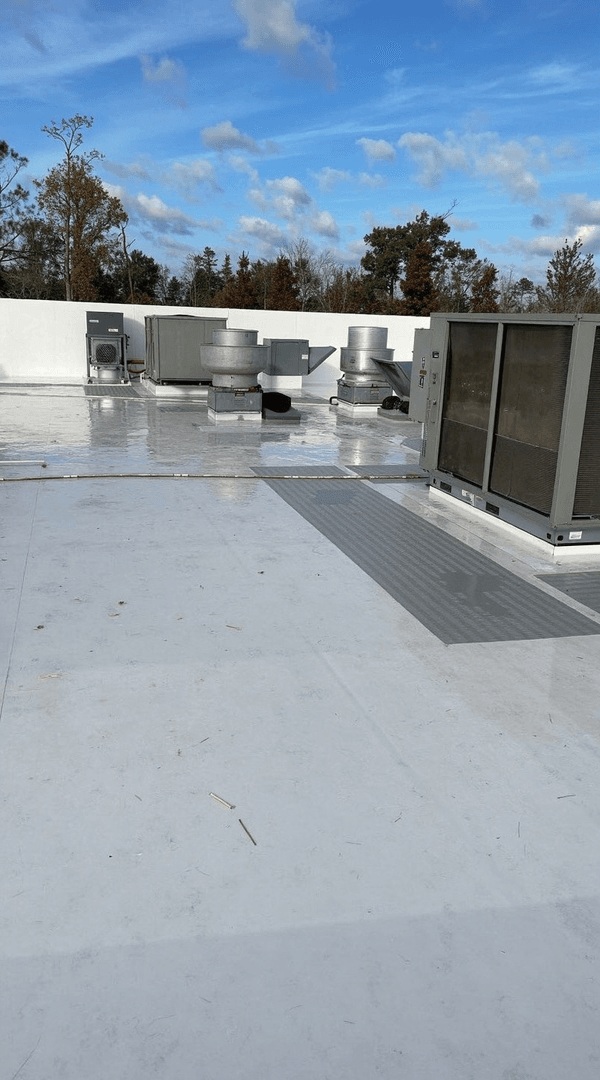Flat commercial roof with HVAC units and a new TPO membrane in Austin