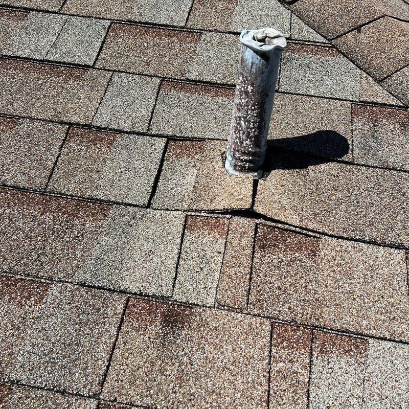 Cracked rubber pipe boot on an asphalt shingle roof, a common source of leaks in Austin