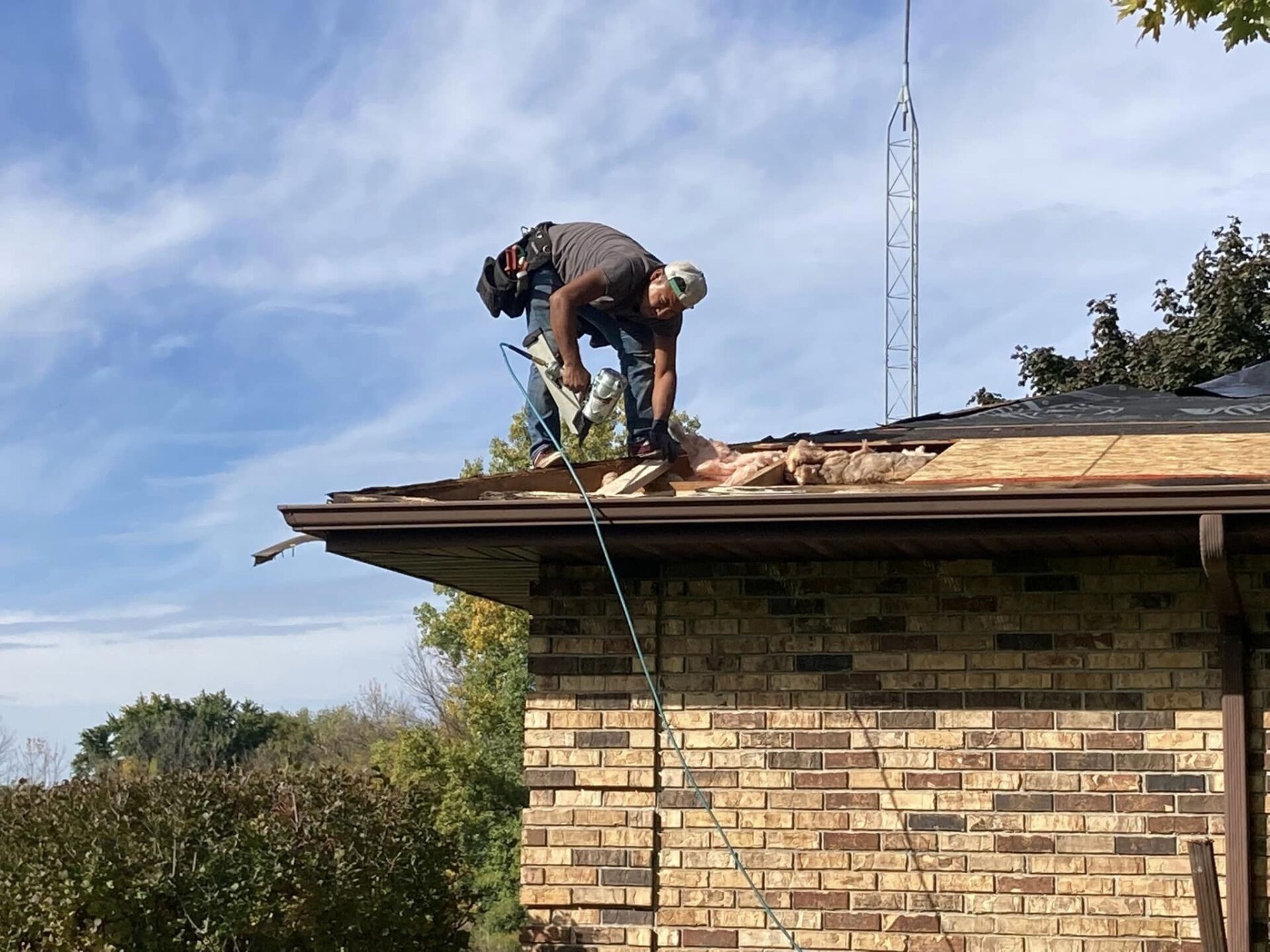Tex Roof technician replacing damaged shingles and flashing on an Austin home