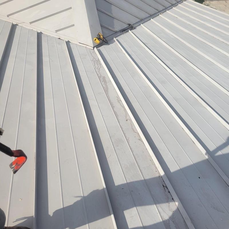 Detail of standing seam metal roof panels and concealed clip fasteners