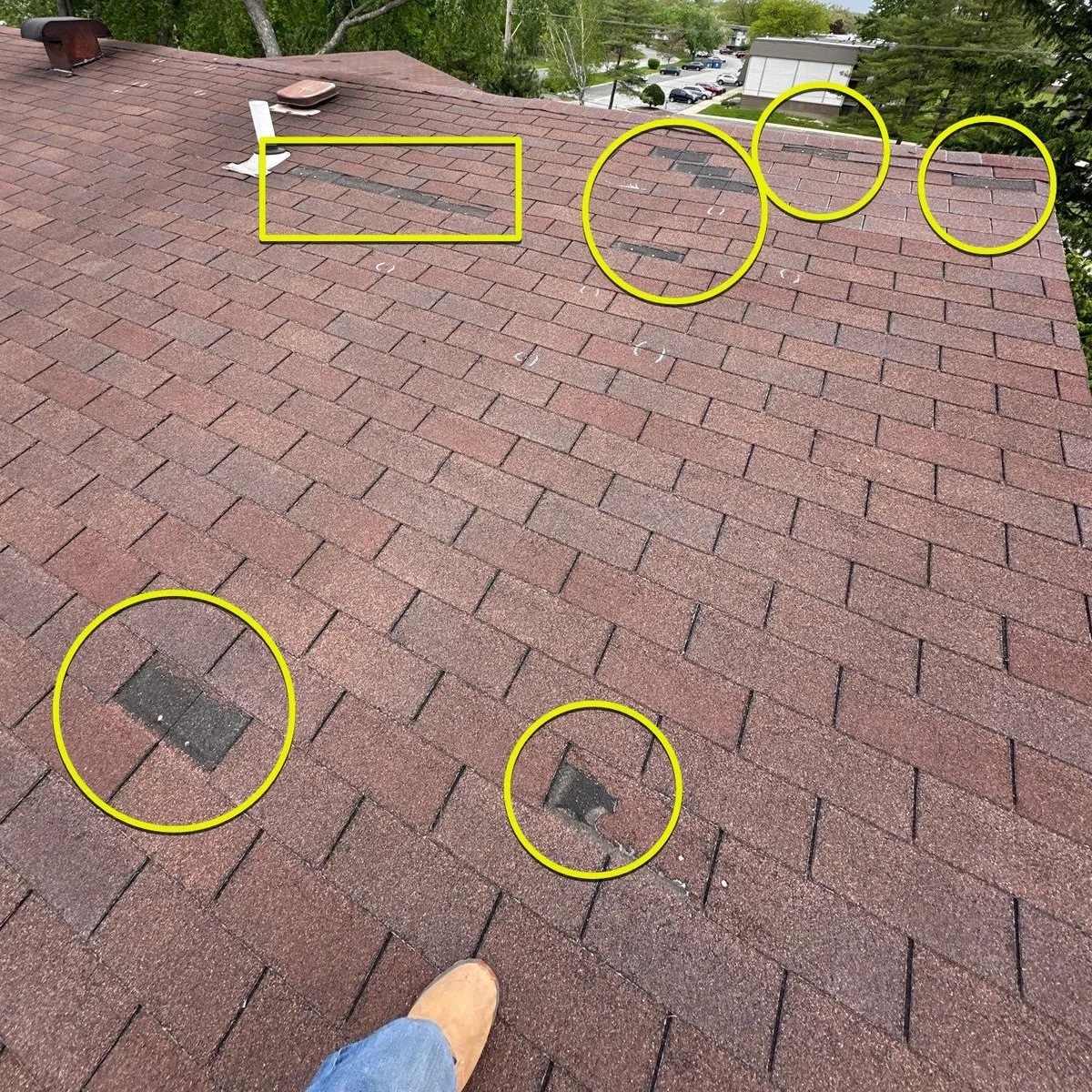 Wind-damaged ridge on a steep Lakeway roof after a Lake Travis storm